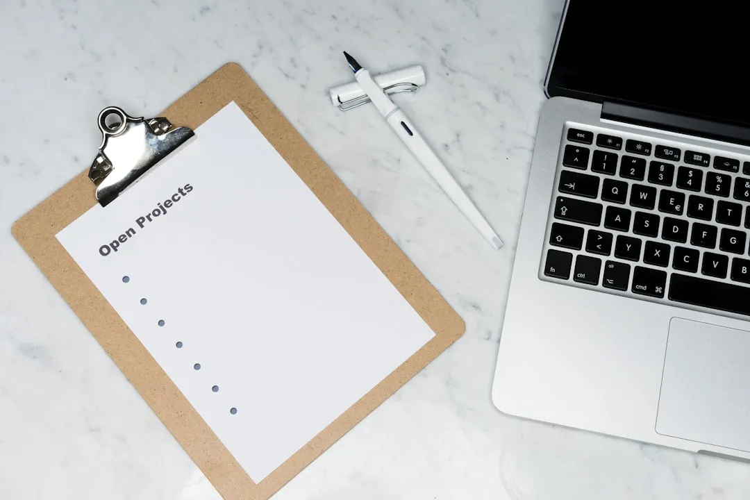 Table with a phone, printed resume, and generic documents, suggesting a checklist to begin the search.