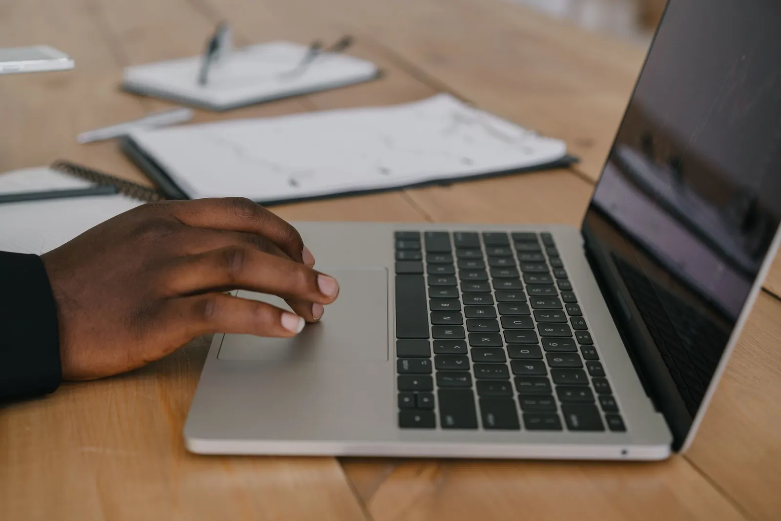 Desk with a phone and laptop suggesting a job search on digital platforms