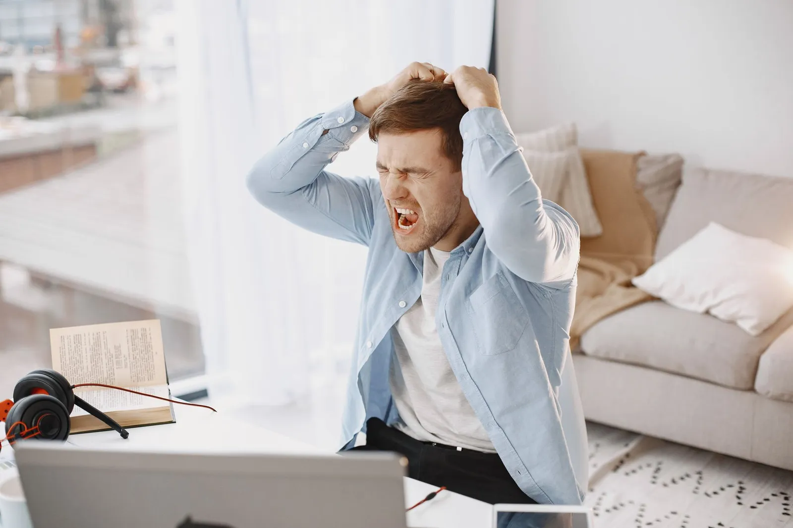 A warning-focused scene with a laptop and security elements to help avoid scams in remote jobs.